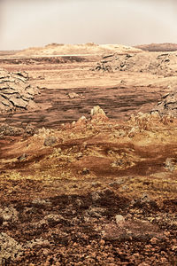 Scenic view of desert land against sky