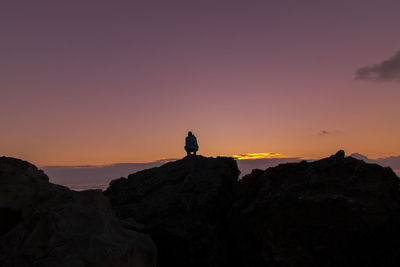 Scenic view of silhouette mountains against sky during sunset