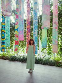 Woman standing against plants