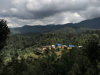 Scenic view of land and mountains against sky