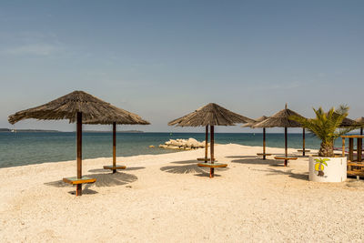Lifeguard hut on beach against sky