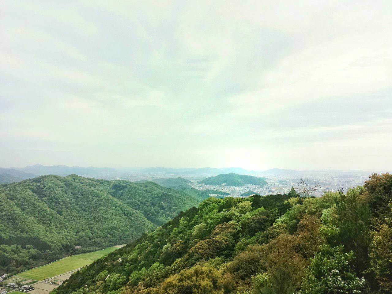 mountain, tranquil scene, scenics, tranquility, sky, beauty in nature, landscape, mountain range, nature, tree, green color, cloud - sky, non-urban scene, idyllic, cloud, cloudy, day, remote, growth, lush foliage