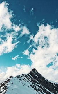 Low angle view of snowcapped mountain against sky