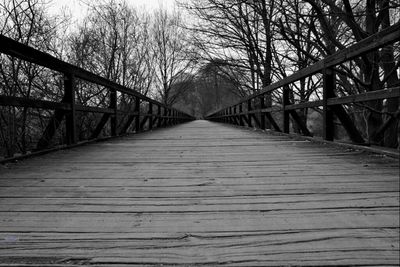 Wooden footbridge with bridge in background