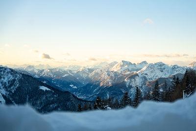 Scenic view of snowcapped mountains against sky during sunset