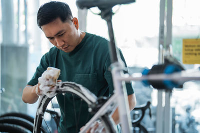 Side view of young man riding bicycle