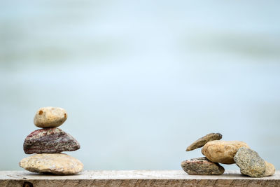 Close-up of stack of rocks against sky