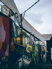 Graffiti on bridge against sky