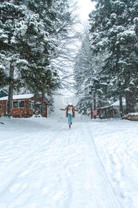 Woman walking on snow covered field