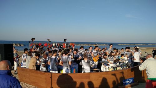 Artists performing orchestra on beach