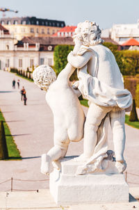 Statue against city in background