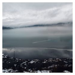 Aerial view of snowcapped mountains against sky