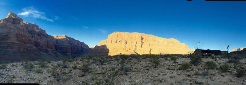 Scenic view of mountains against blue sky