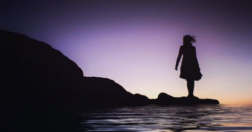 Silhouette of people standing in water