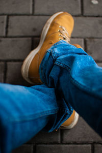 Low section of man sitting outdoors