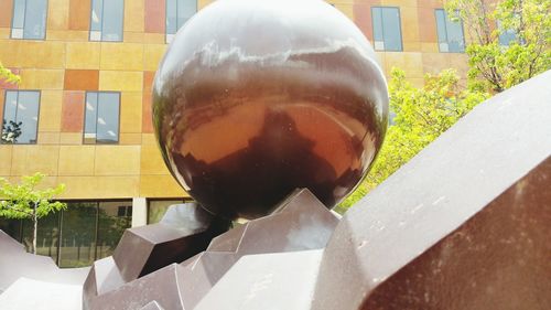 Close-up of reflection on retaining wall in city