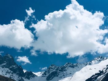 Scenic view of snowcapped mountains against cloudy sky