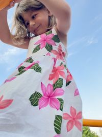 Portrait of smiling girl holding pink plant