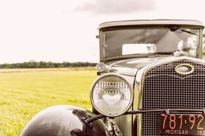 Close-up of vintage car on field