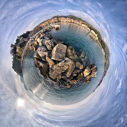 High angle view of rocks in sea against sky