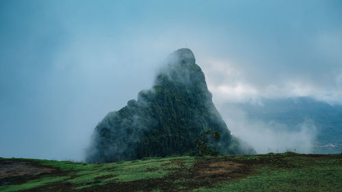 Scenic view of volcanic mountain against sky