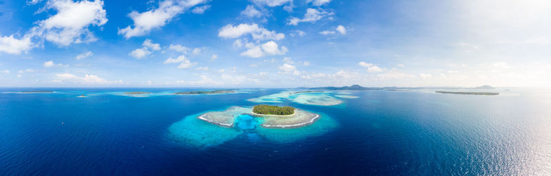 Panoramic view of sea against blue sky