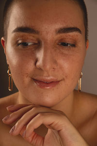 A swarthy girl with short hair and freckles. authentic close-up portrait