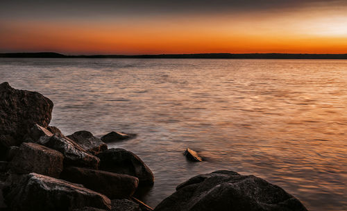 Scenic view of sea against sky at sunset