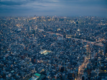 Aerial view of city buildings against sky