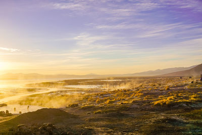 Scenic view of land against sky during sunset