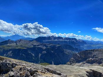 Scenic view of mountains against blue sky