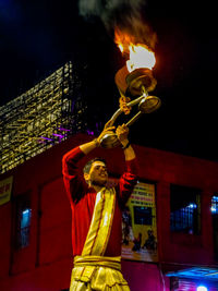 Statue against illuminated building at night