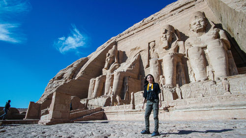 Full length of man standing in front of historical building