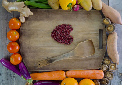 Fruits and vegetables by cutting board with beans