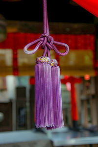 Close-up of multi colored tied hanging on rope