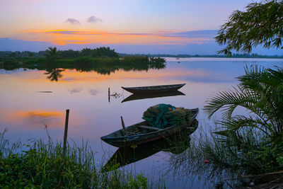 Scenic view of lake against sky during sunset