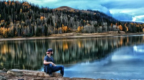 Woman standing on rock by lake