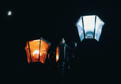 Close-up of illuminated lamp at night