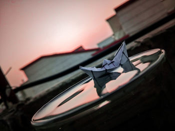 Low angle view of car against sky during sunset