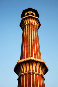 Low angle view of historic column against clear blue sky