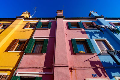 Low angle view of residential building against blue sky