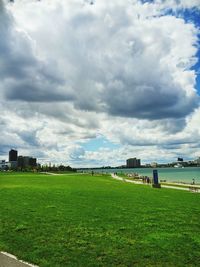 Scenic view of field against cloudy sky