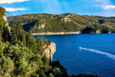 Scenic view of sea and mountains against sky