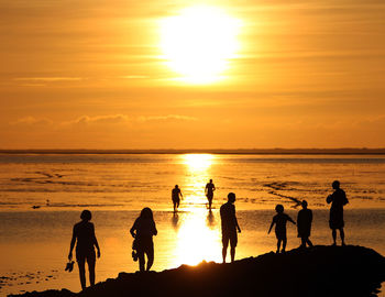 Silhouette of people at sunset