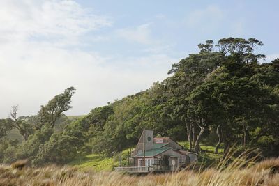 House and trees against sky