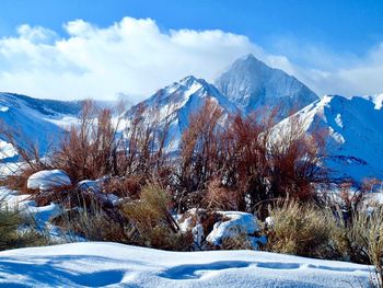 Scenic view of snow covered mountains against sky