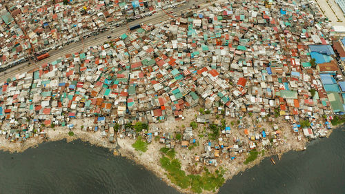 Slums in manila near the port. river polluted with plastic and garbage. manila, philippines.