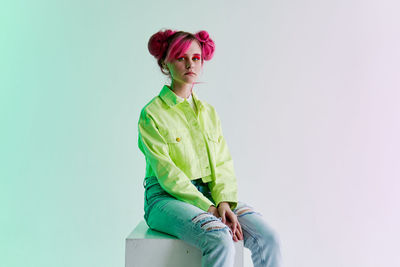 Portrait of woman standing against white background