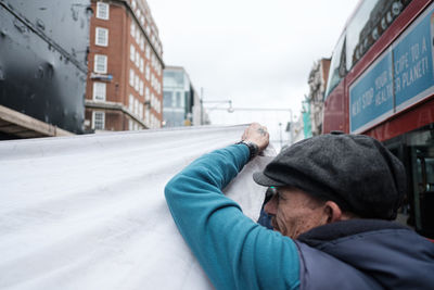 Portrait of man in city during winter