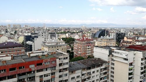 High angle view of buildings in city against sky